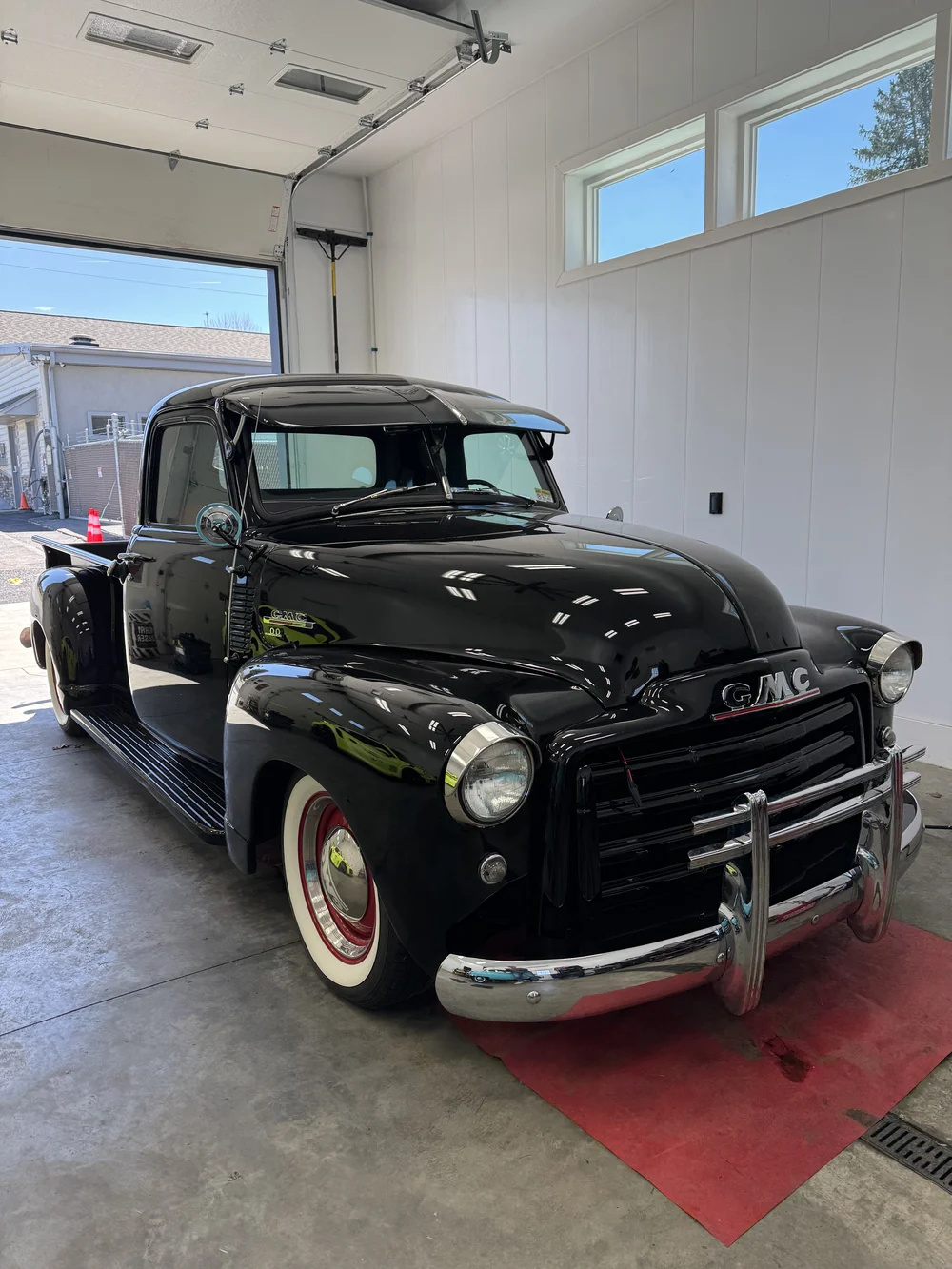 Black vintage pickup truck detailed in the shop