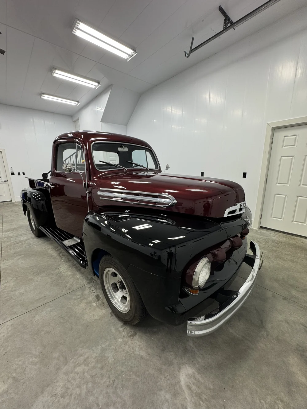 Maroon classic pickup truck detailed in the shop