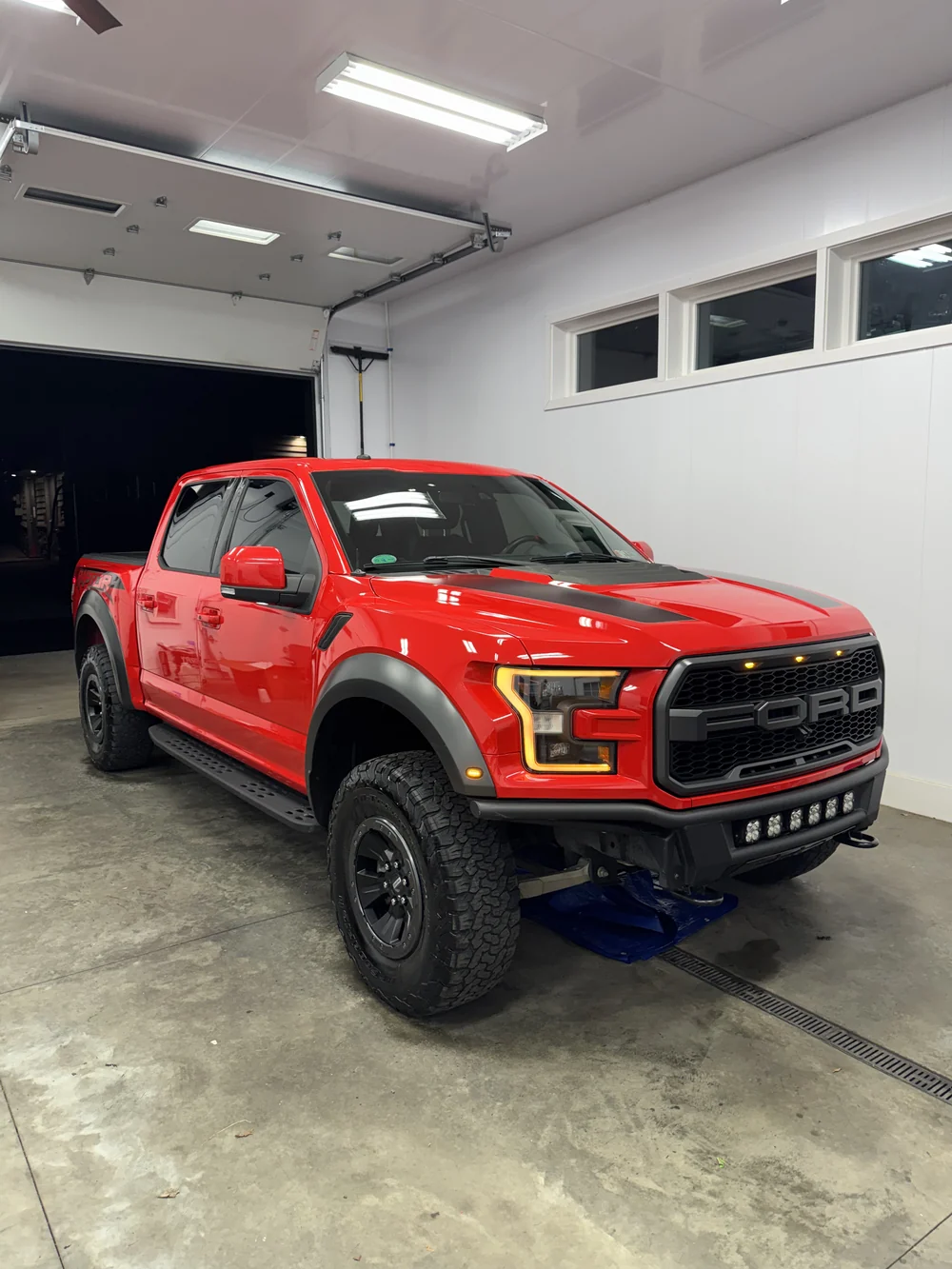 Red Ford F-150 Raptor detailed in the shop